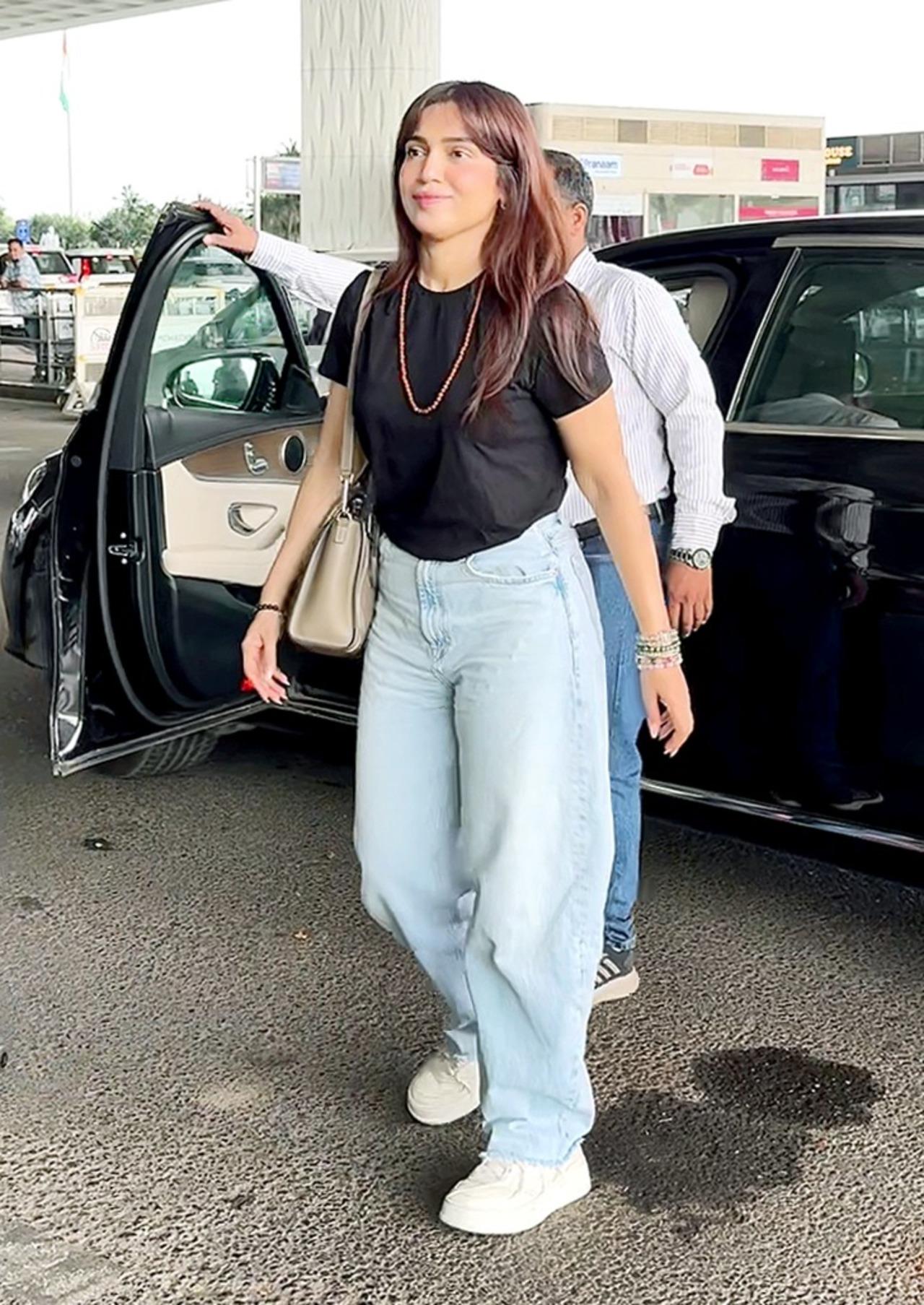 Bhumi Pednekar kept her airport style effortlessly cool in a basic black fitted tee paired with oversized light blue denims. She completed the casual look with minimal accessories.